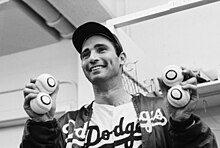 Koufax holds four baseballs, signifying a then-record four career no-hitters, including his perfect game BE050522.jpg