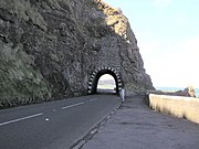 The iconic Blackcave Tunnel or "Black Arch" at the start of the scenic Antrim Coast Road at the northern edge of Larne.