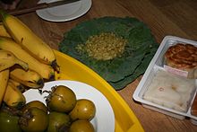 Vietnamese-style green young rice (com) wrapped in lotus leaves, traditionally consumed with ripe bananas and tea during autumn at the beginning of the rice harvest Co trung thu.JPG