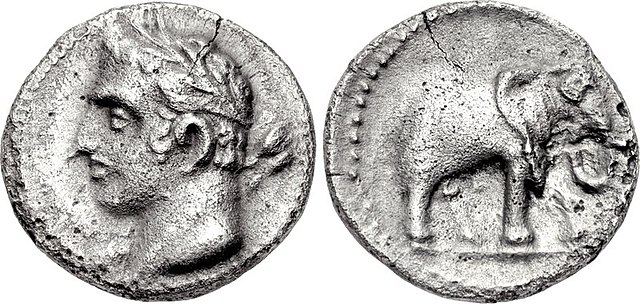 A quarter shekel of Carthage, perhaps minted in Spain. The obverse may depict Hannibal with the traits of a young Melqart. The reverse features one of