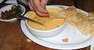 Chile con queso Side dish of melted cheese and chili peppers
