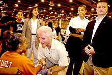 Clinton greets a Hurricane Katrina evacuee, September 5, 2005. In the background, second from the right, is then-Senator Barack Obama. FEMA - 14697 - Photograph by Ed Edahl taken on 09-05-2005 in Texas.jpg