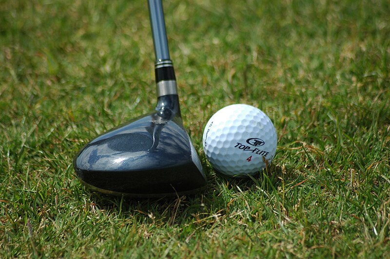 File:Golf ball resting near fairway wood.jpg