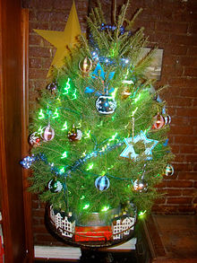 A Hanukkah bush that some Jewish families display in their homes for the duration of Hanukkah and Christmas. Unlike a Christmas tree it would be without any Christianity-themed ornaments and use the colour blue. Hanukkah bush.jpg