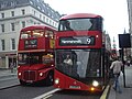 A route 15 Heritage Routemaster overtakes a route 9 New Routemaster on Strand (26 October 2013)
