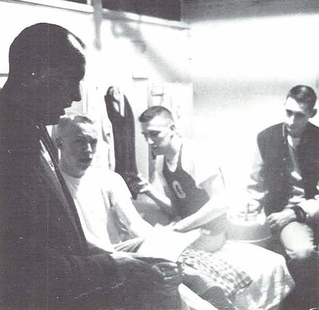 Bowerman (left) conversing with Phil Knight and two other members of the Oregon track team in 1958