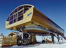 The top of Doppelmayr's "Le Grand Cerf" at Les Sept Laux, outside of Grenoble, France. Chairs exit to the right, gondolas on the left. Les au Laux.jpg