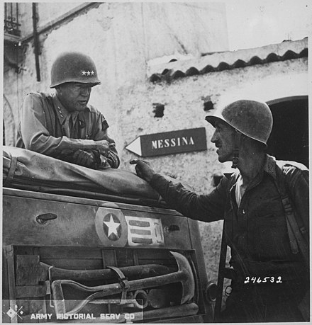 Lieutenant Colonel Lyle W. Bernard, commanding the 2nd Battalion, 30th Infantry Regiment, in conversation with Lieutenant General George S. Patton, commanding the U.S. Seventh Army, near Brolo, Sicily, July 1943.