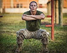 A U.S. Marine Corps officer candidate squatting as an exercise Marine Corps officer candidate participate in physical training.jpg