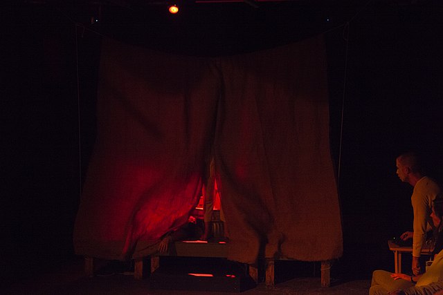 A simple red curtain set design for the Oresteia presented by Stairwell Theater, 2019