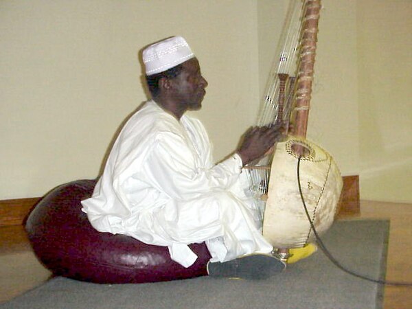 A Mandinka Griot Al-Haji Papa Susso performing songs from the oral tradition of the Gambia on the kora.