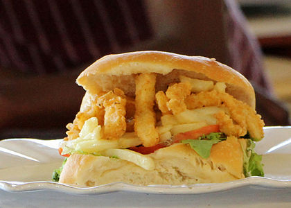 Gatsby sandwich filled with calamari and chips for sale at The Fish Stop stall at Root44 Market, Stellenbosch, South Africa