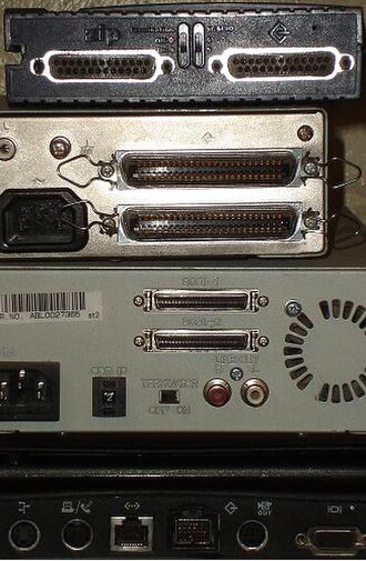 A stack of external SCSI devices displaying various SCSI connectors