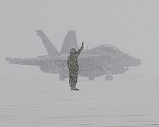Sailor directs an EA-18G during snow storm in Japan (8367035559).jpg
