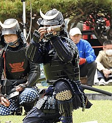 A gunner from the Matsumoto Castle Gun Corps aiming a samurai-zutsu.
