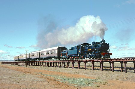 Pmr class locomotive no. 720 was the flagship of the Steamtown Peterborough Railway Preservation Society in the Mid North of South Australia. In May 1984, on an excursion trip, it traversed the iron floodway bridge 2 km south of Black Rock.