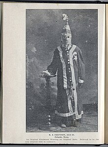 "R. J. Brunson of Pulaski, Tennessee, aged 82. He was part of the original Klan and is wearing an original robe," image published in 1924 (Tennessee Virtual Archive) Tennessee Virtual Archive - An Original Klansman - R. J. Brunson of Pulaski, Tennessee, aged 82. He was part of the original Klan and is wearing an original robe.jpg