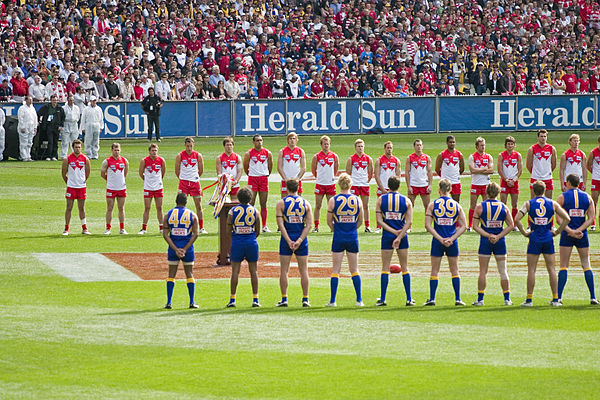 The West Coast Eagles and Sydney Swans line up for the national anthem at the 2005 Grand Final.