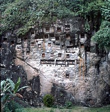 A Torajan tomb in a high rocky cliff is one of the tourist attractions in Tana Toraja. Toraja tumbs.jpg