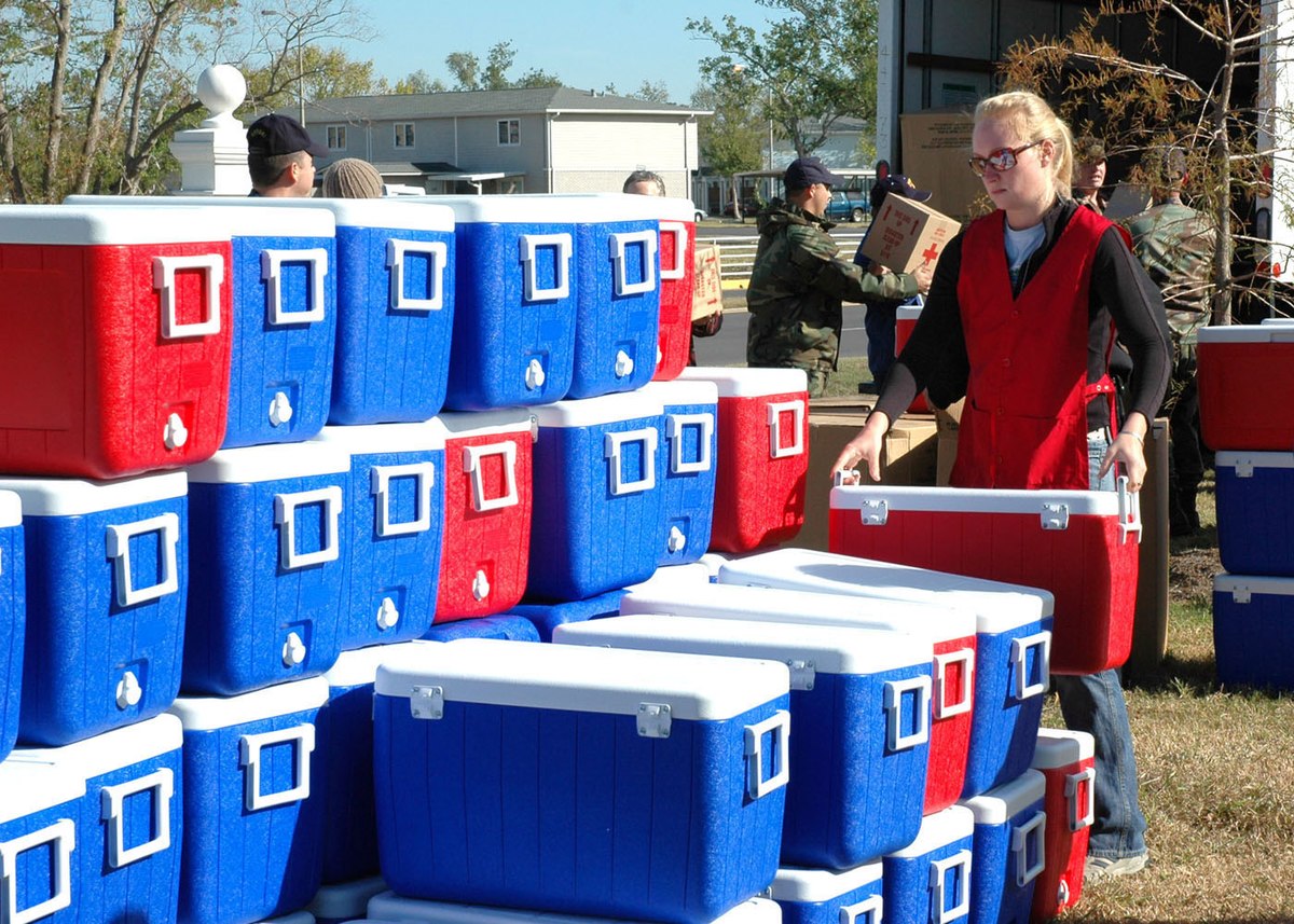 https://upload.wikimedia.org/wikipedia/commons/thumb/6/6e/US_Navy_051213-N-9274T-003_Molly_Reagan%2C_a_volunteer_with_The_American_Red_Cross%2C_stacks_coolers_brought_to_New_Orleans_by_The_American_Red_Cross.jpg/1200px-US_Navy_051213-N-9274T-003_Molly_Reagan%2C_a_volunteer_with_The_American_Red_Cross%2C_stacks_coolers_brought_to_New_Orleans_by_The_American_Red_Cross.jpg