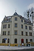 Apartment house in a corner and open development