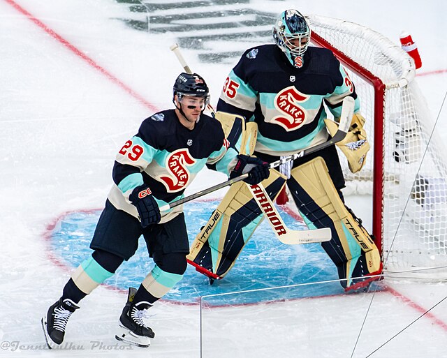 Vince Dunn (left) and Joey Daccord (right) during the 2024 NHL Winter Classic wearing uniforms inspired by the Seattle Metropolitans.