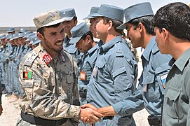 Afghan Brig. Gen. Abdul Raziq shakes hands with Afghan police instructors at Kandahar Regional Training Center .jpg