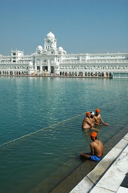 Pilgrims bathing in the Amrit Sarovar