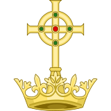 The heraldic badge of Wales Herald Extraordinary which depicts the Cross of Neith atop a Welsh Talaith, logically that of Llywelyn. Badge of the Wales Herald Extraordinary.svg