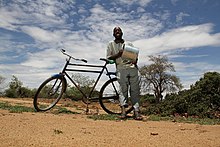 Man cycling on a road in Buhera District Blue sky bicycle man.jpg