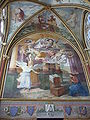 Scène sur un grand mur, avec l'ange à gauche et la Vierge agenouillé en bas à droite