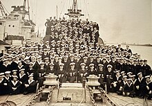 The crew of HNLMS Tjerk Hiddes with Lieutenant Commander WJ Kruys (front row, center)