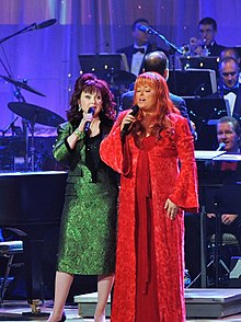 Country music duo The Judds, performing at the edge of a stage.