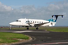 An Eagle Airways Beechcraft 1900D taxis to runway 23L at Auckland International Airport. Eagle Airways Beechcraft 1900D taxiing at Auckland Airport.JPG