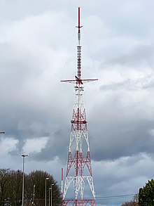 Wavre Transmitter features an unusual design that uses a guyed upper section to hold the transmitter in place Emetteur de Wavre.jpg