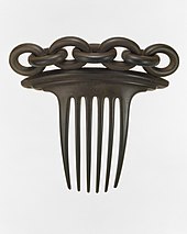 A rubber hair comb in the exhibit, evoking another comb uncovered during the Seneca Village Project. Hair Comb MET DT4707.jpg