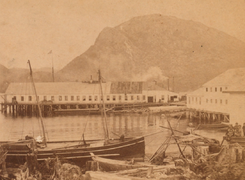 A cannery with a small docked fishing vessel Indian Salmon Cannery, New Metlakahtla, Alaska (cropped).png