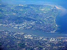 The northern tip of the Wirral peninsula looking west from a position over Liverpool. Liverpool Docks and the Wirral.jpg