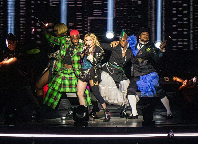 Madonna singing "Everybody" on the Celebration Tour (2023–2024). Released as her debut single, the song's success led her to be signed up and offered 