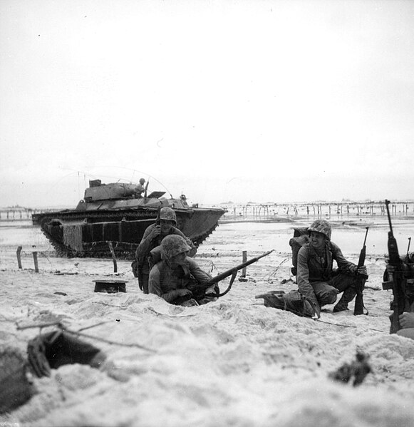 File:Marines moving along the beach cautiously while an amphibious tractor covers them on Peleliu. September, 1944. (53398741905).jpg