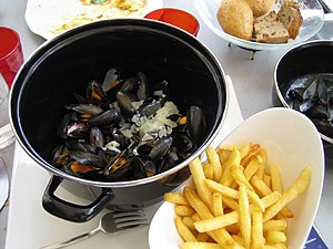 Moules-frites is a Belgian dish of mussels and fries.