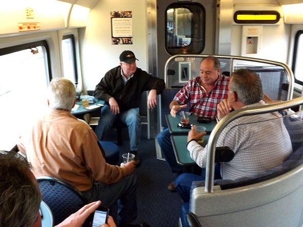 Passengers in the lounge seating area in the café car of a San Joaquins train, 2014