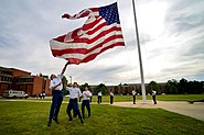 Army soldiers from the Defense Information School lower the flag, 2014