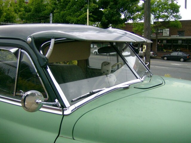 Split and raked windshield on a 1952 DeSoto. Note the panes of glass are flat.