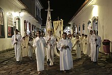 A Christian procession in Brazil, the country with the largest Catholic population in the world. Reabertura Museu de Arte Sacra (18626301050).jpg