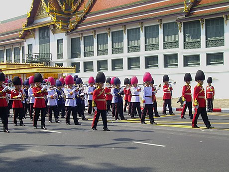 The Royal Thai Army Band in uniforms of various royal guards unit, ranked in the shape of the flag of Thailand
