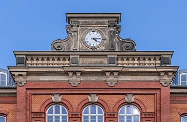 Gable with clock of a neo-renaissance styled school in Hof, Germany