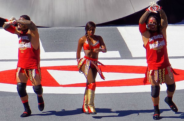 The Usos with Naomi making their entrance to the ring at the WrestleMania 31 pre-show in March 2015