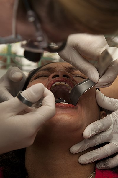 File:U.S. Army Capt. Pamala Cotton, a medical officer with the 65th Medical Brigade, performs a tooth extraction during a cooperative health engagement (CHE) at Inhobol Elementary School in Masinloc, Zambales 130405-M-UY788-045.jpg