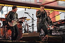 U2 perform at the 2014 World AIDS Day Concert, with Bruce Springsteen filling in for an injured Bono as vocalist U2 with Bruce Springsteen at World AIDS Day Concert Dec 2014.jpg